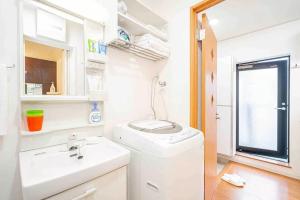 un bagno con lavatrice e lavandino di Akihabara Skytree Premium Apartment 102 a Tokyo Altre 30 foto