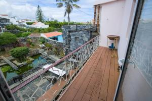 a balcony with a view of a pool at Flor do Mar House in Ponta Delgada