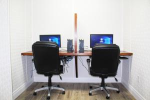 an office with a desk with two chairs and a computer at Hotel North in North Sydney