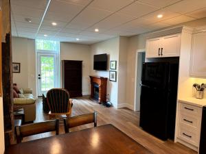 a kitchen and living room with a black refrigerator at Burk's Fall River View 2b2b in Burks Falls