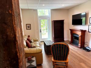a living room with a couch and a fireplace at Burk's Fall River View 2b2b in Burks Falls
