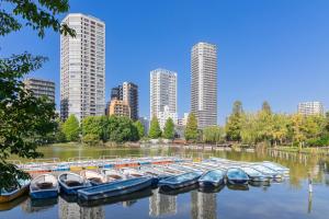 a bunch of boats docked in the water in a city at 365Ueno in Tokyo