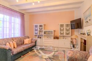 a living room with a couch and a table at Makiaris Villa in Archangelos +29 photos