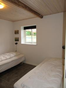 een slaapkamer met twee bedden en een raam bij Hedelodden Apartment in Uve +17 foto's