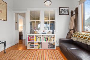 a living room with a book shelf filled with books at Bright 3 Bed House with Garden BBQ & Fireplace in Blackheath