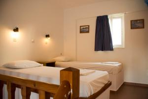 a room with two beds and a window at Level Houses in Kefalos