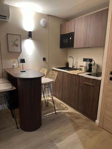 a small kitchen with a table and chairs in it at Le Lodge du Caillotin in Rosières-près-Troyes