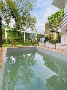 a swimming pool in the middle of a house at PUNTUSH By The StayCationer in Dehradun