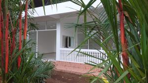 a view of a house through some palm trees at My Dream Home Sri Lanka in Weligama