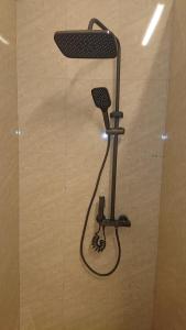 a shower in a bathroom with a blow dryer at My Dream Home Sri Lanka in Weligama