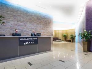 two men sitting at a reception desk in a lobby at Location! Brisbane City Centre! Whole Apartment! in Brisbane +15 photos