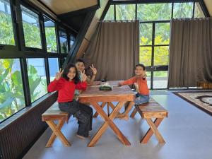 a group of people sitting at a table at Cherry Blossoms Chalet in Kozhikode
