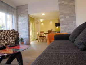 a living room with a couch and a table at Apartments Jukic in Klis