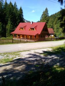 a log cabin with a red roof at Privat Mikyska in Terchová