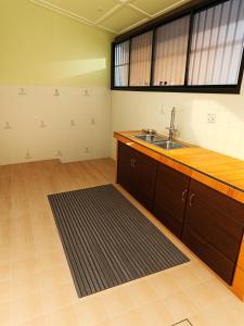 a kitchen with a sink and a counter top at Econo Homestay in Ipoh