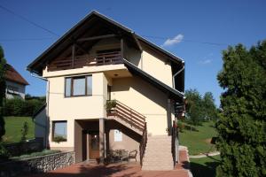a white house with a black roof at Apartment Ante in Slunj