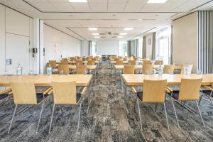 an empty room with tables and chairs in it at Best Western Plus Hotel Papenburg in Papenburg