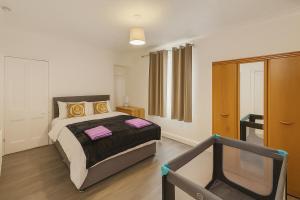 a bedroom with a bed with pink towels on it at Stunning 5 Bedroom Home in the Heart of Swansea - Snooker Table, WiFi & Parking! in Swansea