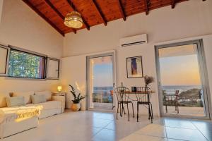 a living room with a couch and a table at Balcone Ionico in Agios Andreas