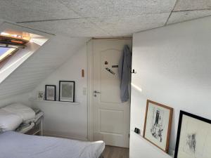 a room with a bed and a staircase with a door at Beautiful house with a charming garden in Brønderslev