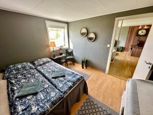 a bedroom with a bed and a living room at Cozy Landscape House, Near pulpit Rock in Strand