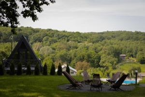 a group of lawn chairs sitting in front of a pool at Lav inn Polyanna Простір in Polyana