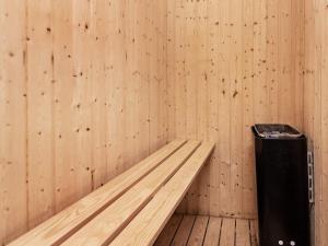 a room with a bench and a trash can at 4 star holiday home in Allingåbro in Nørager