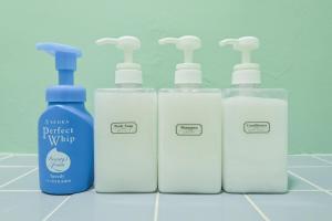 a group of four bottles of detergent sitting on a counter at 幸Happiness 10 Guests Near Narita temple park&Narita Airport 3 Parking Spaces Spacious Home in Narita +18 photos