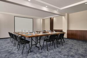 a conference room with a long table and black chairs at La Quinta By Wyndham Istanbul Kartal in Istanbul