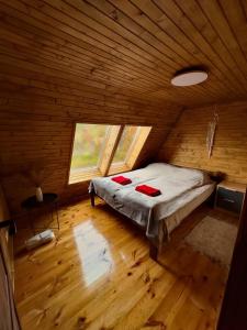 a bedroom with a bed in a wooden cabin at Lav inn Polyana Затишок in Polyana +24 photos