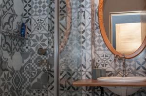 a bathroom with a shower with a sink and a mirror at Roberta Hercberga Apartamenti in Kuldīga +23 photos
