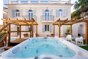 a hot tub on a patio in front of a house at Ravello House in Ravello