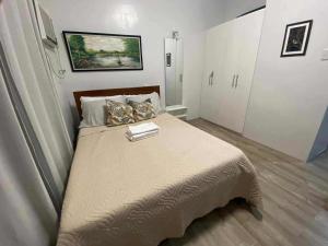 a bedroom with a large bed in a room at Isabela III, Mesavirre Garden Residences in Bacolod +1 photo