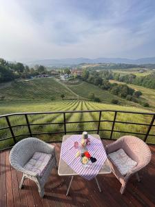 a table and two chairs on a deck with a view at Glamping La Piaggia in Poppi