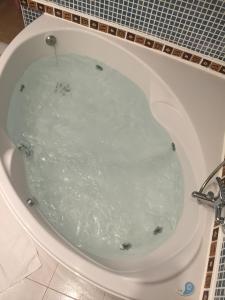 a bath tub filled with water in a bathroom at Sitges Studio in Sitges