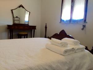 a bedroom with a bed with towels on it at Private Room in Old Town in Viana do Castelo