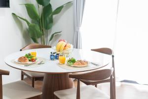 a white table with plates of food on it at The Emu Park Tsushima in Tsushima