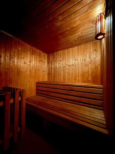 a wooden bench in a room with a light on it at Sklepní apartmán se saunou in Plzeň