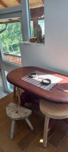 a wooden table with two chairs next to a window at Smeštaj Nikolić in Arilje