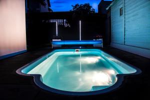 a swimming pool in the middle of a yard at night at Apartamenty Olivia in Władysławowo