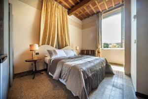 Postel nebo postele na pokoji v ubytování Lucca Relais