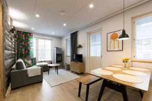 a living room with a dining room table and a couch at Levin Sirius Apartments Visit Levi in Levi