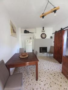 a living room with a wooden table and a couch at Με θέα το Αιγαίο in Agia Marina Lesvos