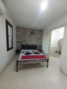 a bedroom with a bed in the middle of a room at Με θέα το Αιγαίο in Agia Marina Lesvos