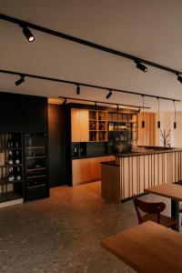 a large room with a kitchen and a bar at Vineyard Escape Herbersteinova klet in Juršinci