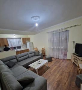 a living room with a couch and a table at Central Apart Permet in Përmet