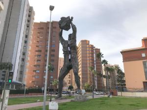 a statue of a man standing in a city at LC Apartaments Centro Menedez 3 hab & 2 baños in Castellón de la Plana