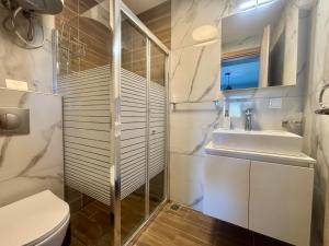 a bathroom with a sink and a toilet at Chloe Stay Complex by Horizon Homes in Orfánion +16 photos