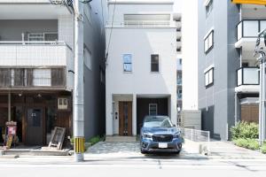a car parked in front of a building at yah homes takasago in Fukuoka