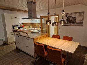 a kitchen with a large wooden table and chairs at Ferienhof Weitblick in Oy-Mittelberg